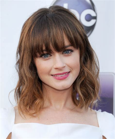 Hair cuts with a fringe - 23. Thick Feathered Lob with Bangs. Here’s the feathered hair with a fringe that can effectively tame your thick locks and create a chic, modern look! Layers in this medium length feathered hair create an interesting shape, adding lightness to your tresses, and golden blonde hair color makes hair shinier.